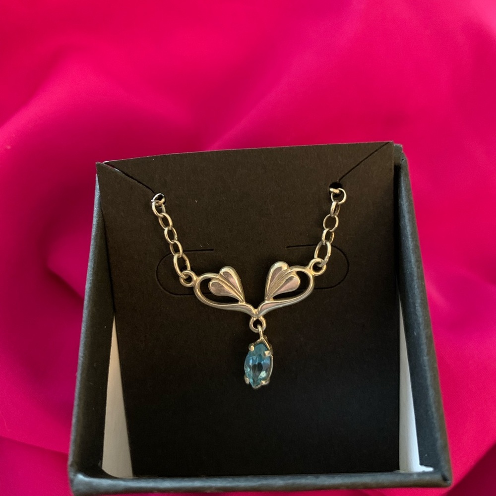 Sterling silver necklace with blue topaz.